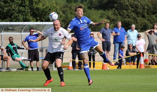 EYES WIDE SHUT . . . Athletic striker Lee Erwin attempts to win a header