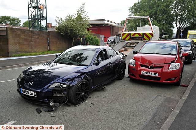 RTA on Trough Gate, Hollins. Blue car shunted red car into a man who was unloading from his silver Volvo to his takeaway 'Ocean Palace'.