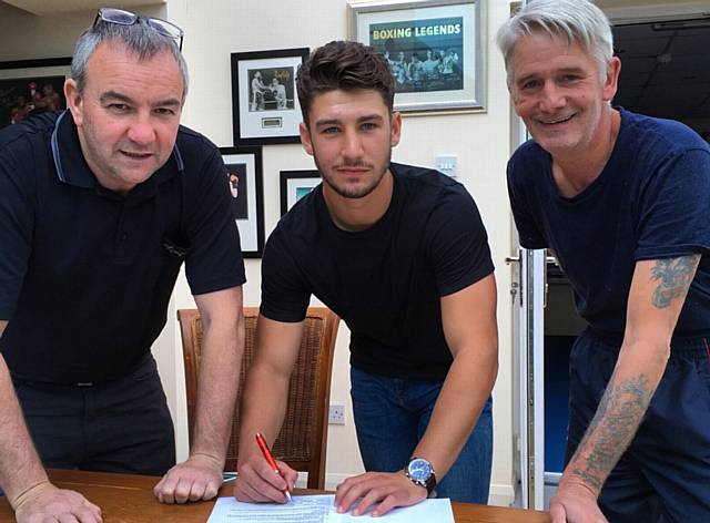 SIGN HERE . . . Danny Wright with Steve Wood (left) and trainer Ben Lancaster