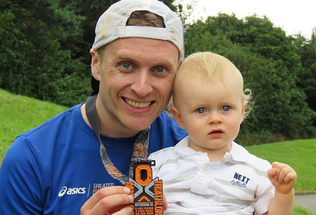 Matt Longbottom shows off his medal to son Harry (1)