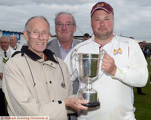 SIMON Wright receives the Tanner Cup from Roger Tanner, with league chairman Nigel Tench looking on