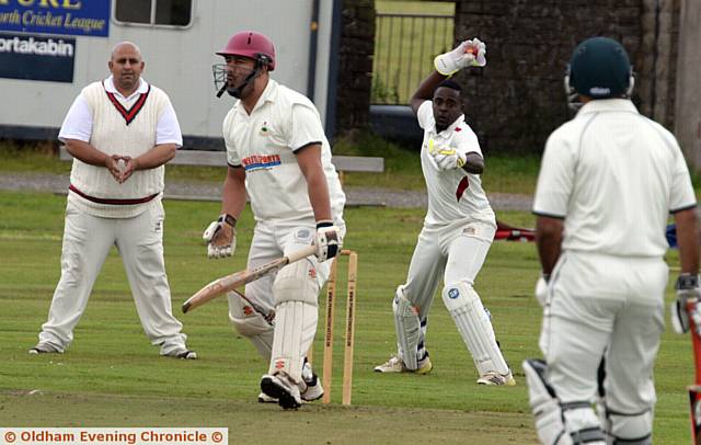 TAKING AIM . . . Friarmere wicketkeeper Anton Lucas-Jones tries to catch Werneth's Ali Umar out of his crease