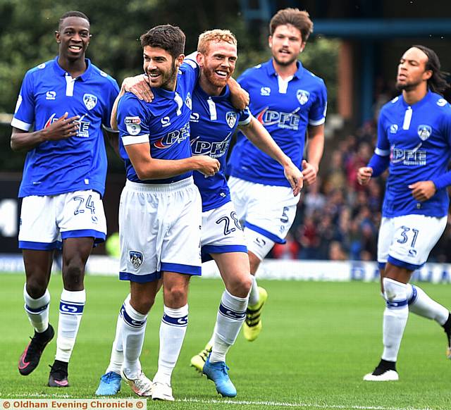 SMILES ALL ROUND . . . Ryan Flynn (left) and Paul Green show their delight after Athletic take the lead at Gigg Lane