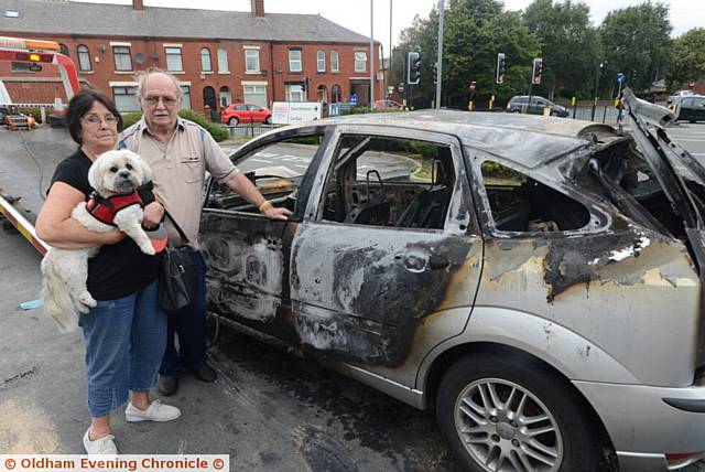 ELLISON and Edna Thomas with their dog Belle next to their wrecked car. Picture by ANTHONY MILLER
