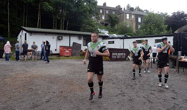 GOING, GOING . . . players emerge from the soon-to-be demolished clubhouse