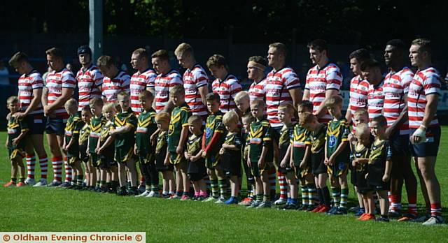 SILENT RESPECT . . . Players and mascots pay tribute to Steve Gartland