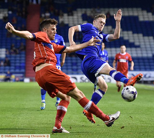 CHARGE DOWN . . . Billy Mckay tries to block a Carlisle clearance. PICTURES by ALAN HOWARTH