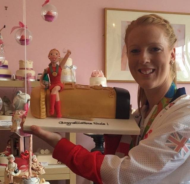 NICOLA with her cake to celebrate gold