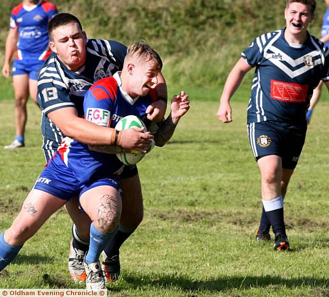 GOTCHA . . . Hollinwood's Tom Wilson (left) grabs an Ossett player as he makes a break in the Pennine League clash
