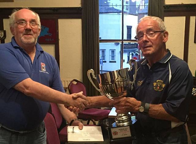 TROPHY TIME . . . Hollinwood's Fred Halliwell (left) with Oldham Amateur League secretary Phil Bradbury