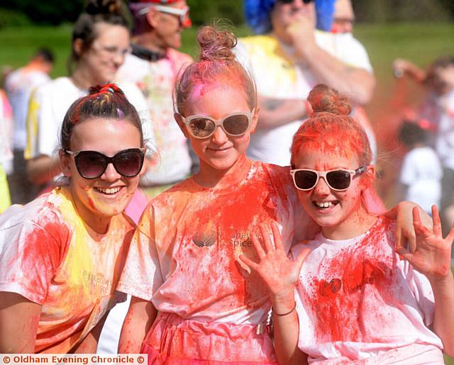 ALL in red . . . Evie Herring (10), Olivia Kershaw (9) and Milly Massey (9)