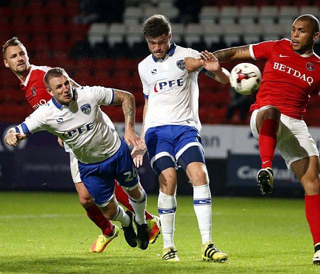 HEAD TURNER . . . inspirational skipper Peter Clarke nets Athletic's equaliser in the Sky Bet League One clash against Charlton last night

