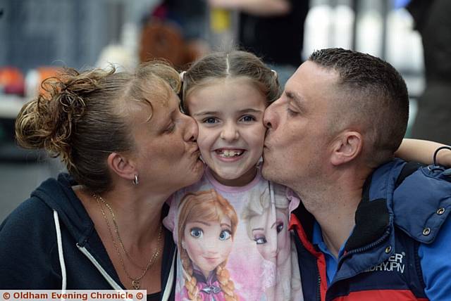 Community raise funds for Limeside girl Kacee Jo Crutchley at Oasis Academy, Oldham. Pictured here are (l-r) mum Joanne Crutchley, Kacee Jo Crutchley and dad Jason Crutchley