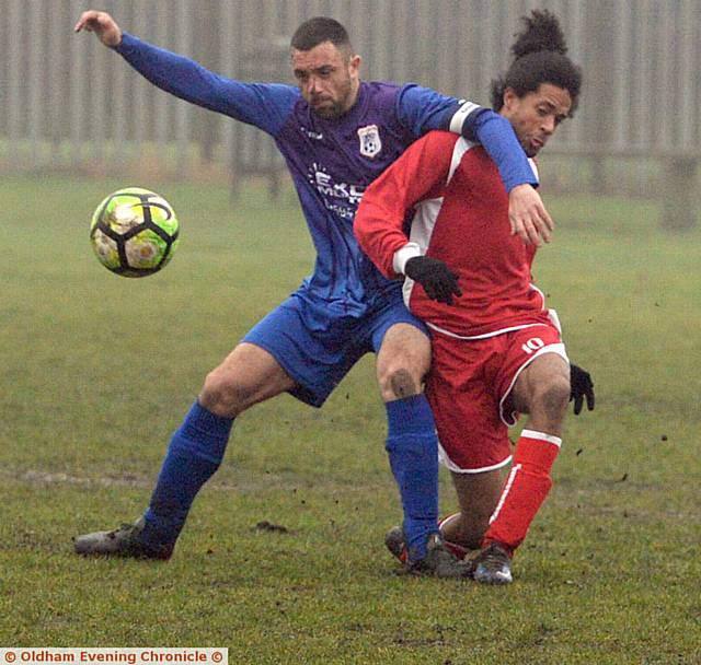 GETTING STUCK IN . . . Crown's Andy Walker (left) and Springhead Libs' Daniel Gordon