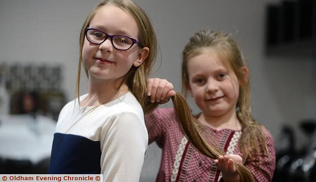 SISTER Millie holds Lottie's hair before the cut