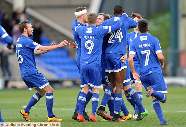 JOSH JOY...Josh Law is mobbed by his team-mates after putting Athletic in front - but he is released