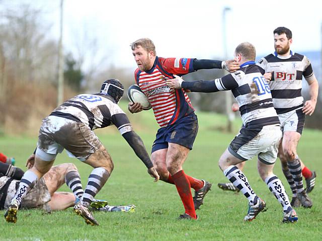 DETERMINATION...Oldham's Gareth Blomeley charges towards the Trafford MV line