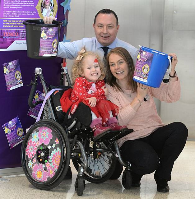 THANKS . . . Millie Moran with Tesco Oldham Extra, store manager Andrew Brown and customer experience manager Angela Mullarkey