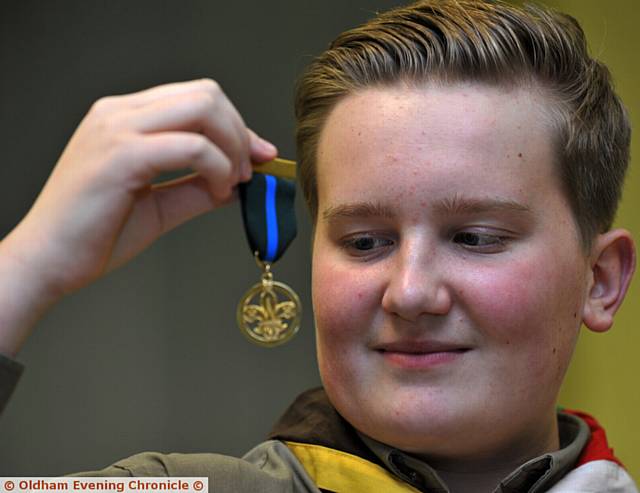 SCOUT hero . . . Ethan Curley admires his medal