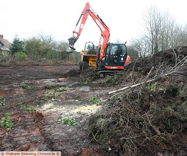 Local resident, Christine Wise, who lives close to Whitebank stadium, attempts to get mechanical diggers stopped from digging up council land close to the stadium. The area has badger sets in the area of the dig. Pic shows, how much of the land has been worked on by the diggers.
