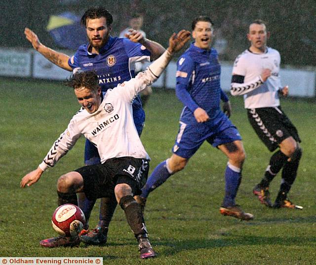 MOSSLEY'S James Blair feels the force of a challenge. 