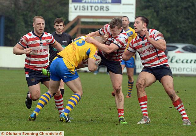 HOLDING ON: new Oldham RL captain Gareth Owen tries to halt a Swinton Lions attack