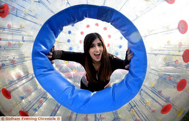 HAVING A BALL . . . Haffsah Nazir goes Zorbing at Hathershaw College staff enrichment activities
