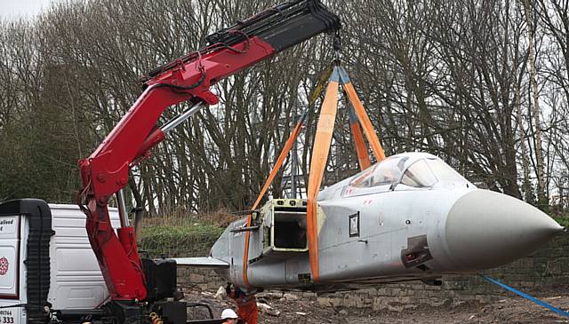 EASY does it . . . the Tornado is lifted into place at the new firefighter centre