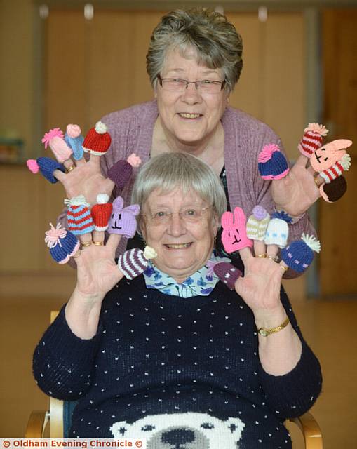 Doreen Hopwood, top, and Anne Ashton with some of the mini hats