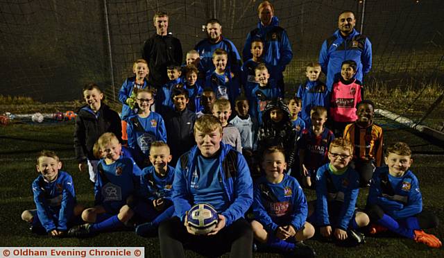 OLD HEAD ON YOUNG SHOULDERS . . . 19-year-old Sam Coleman (front centre) who coaches at Hollinwood JFC, Chapel Road playing fields