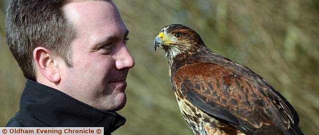 LUKE Summers who has given up his job as a corporate development manager to become a mobile bird and pest technician, a falconer. He is pictured with Scarlett, a young Harris Hawk.
