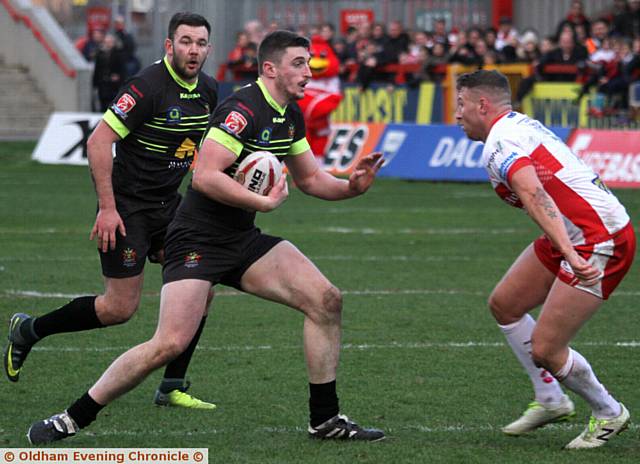 ON THE RUN . . . Oldham prop forward Joe Burke heads into battle