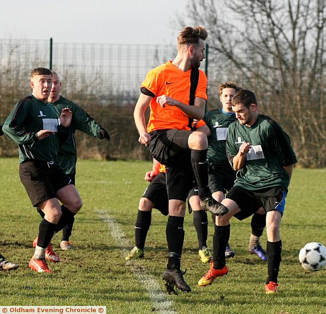 SO CLOSE . . . Daisyfield's Craig Taylor (orange shirt) takes a shot. PICTURES by PAUL STERRITT
