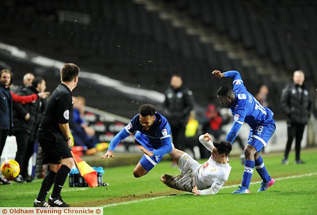 HEADING FOR A FALL...Athletic's Aaron Amari-Holloway takes a tumble against MK Dons last night. PICTURES by ALAN HOWARTH