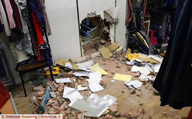 SMASHED . . . a hole in the wall to gain entry to the post office next door