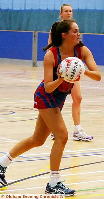 ON THE BALL . . . Amy Neild looks for a team-mate