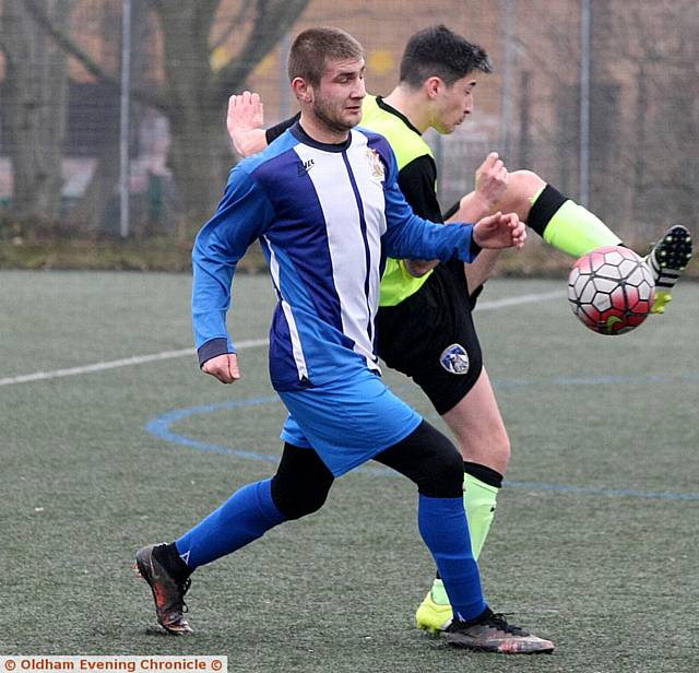 GETTING STUCK IN . . . Hollinwood's Volodohyr Sheludchenko (blue strip). Pictured (inset) is Abel Tsegay whipping in a cross. GETTING STUCK IN . . . Hollinwood's Volodohyr Sheludchenko (blue strip). Pictured (inset) is Abel Tsegay whipping in a cross.