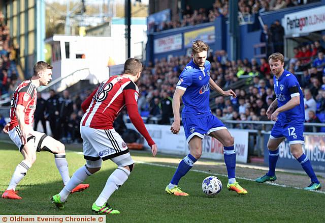 ON THE BALL . . . Athletic' s Ollie Banks is under pressure from the Blades defence with Chris Taylor hugging the touchline.