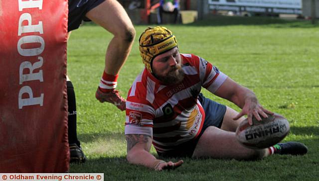 TOUCHING DOWN . . . Oldham's Michael Ward registers