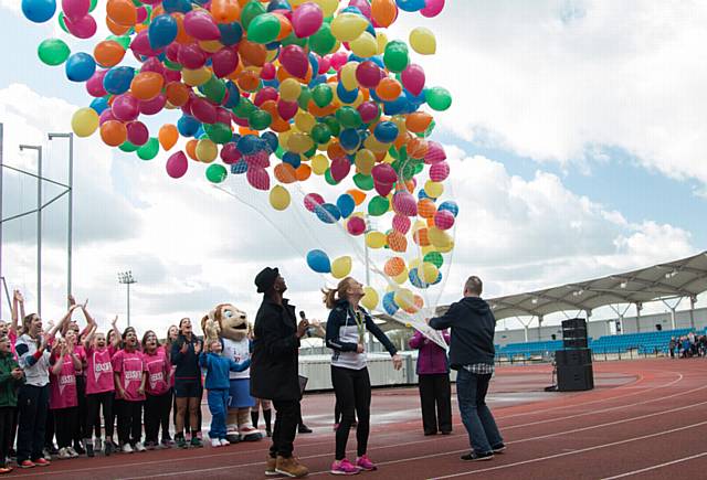 THE balloons go up . . . Oldham's gold medal winning hockey star Nicola White opens the Games