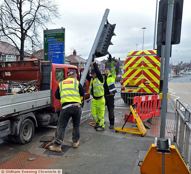 SCENE . . .Workmen repair the traffic lights on Broadway