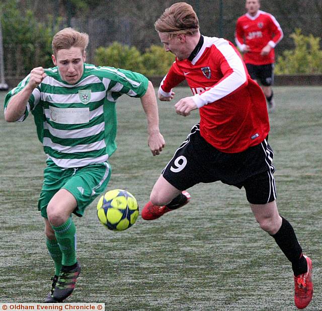 ON THE CHARGE . . . King George's Leon Melia (right) tries to get past a Charlestown opponent