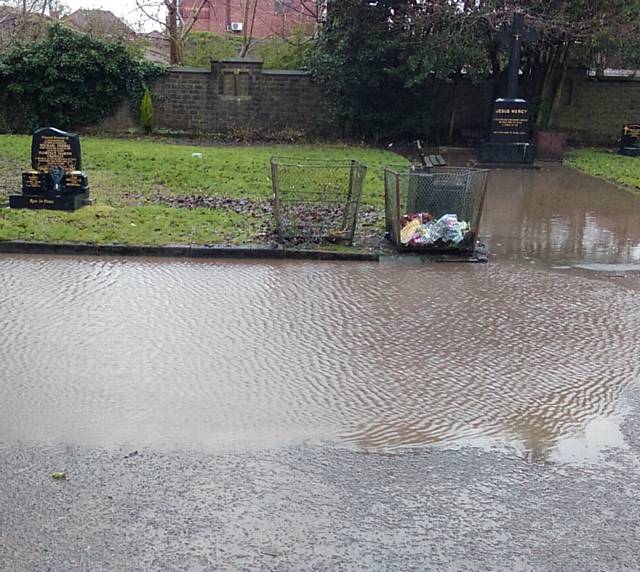 FLOOD . . . Graves and paths flooded at the cemetery
