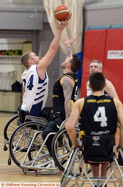 REACH UP. . . Martin Edwards (left), of Oldham Owls, and an Essex Outlaws rival at the tip off