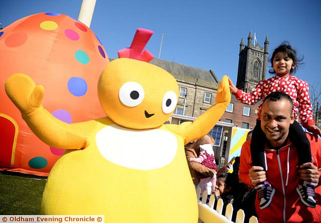 HIGH fives . . . Sophia Ali (three) with dad Joynul Ali meet Chickedy from the Twirlywoos in Parliament Square