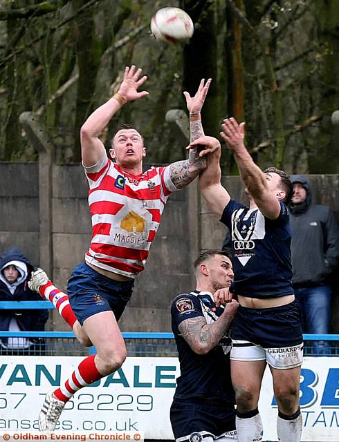 JUMP TO IT: Oldham's Scott Turner leaps for a high ball during the Good Friday game against Swinton at Bower Fold