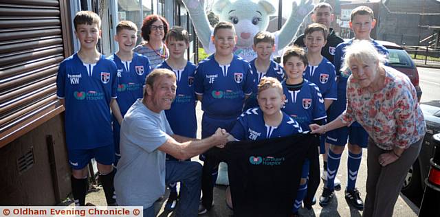 SPRINGHEAD AFC U12s Owls are presented with their kit by L.Smith Bakery. Pictured front, from left, Lawrence Smith, captain Zak Wareing (12) and Pat Kirk