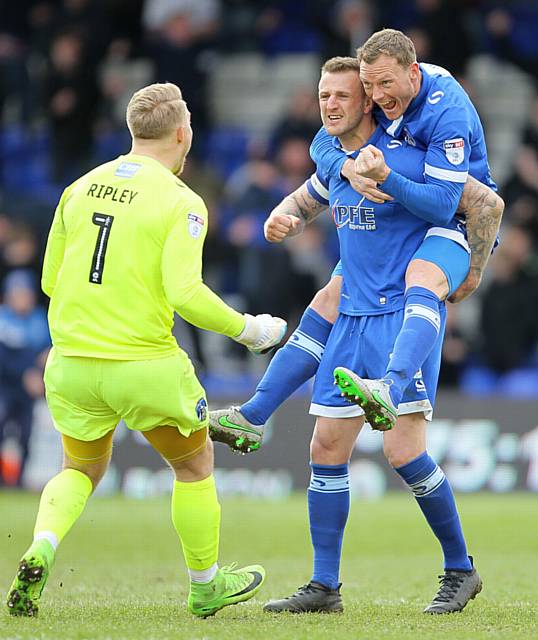 GET IN . . . Athletic captain Peter Clarke (centre), Connor Ripley (left) and Brian Wilson celebrate after victory over Bolton