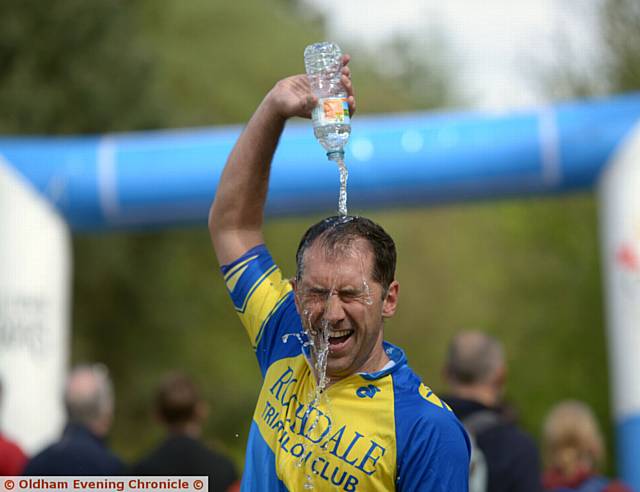 FINISH . . .Mike Winterburn cools down after he finishes the triathlon