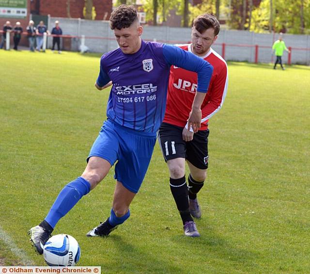 ACTION STATIONS . . . Crown's Joe McNamara shields the ball from Limeside's Joe Heap